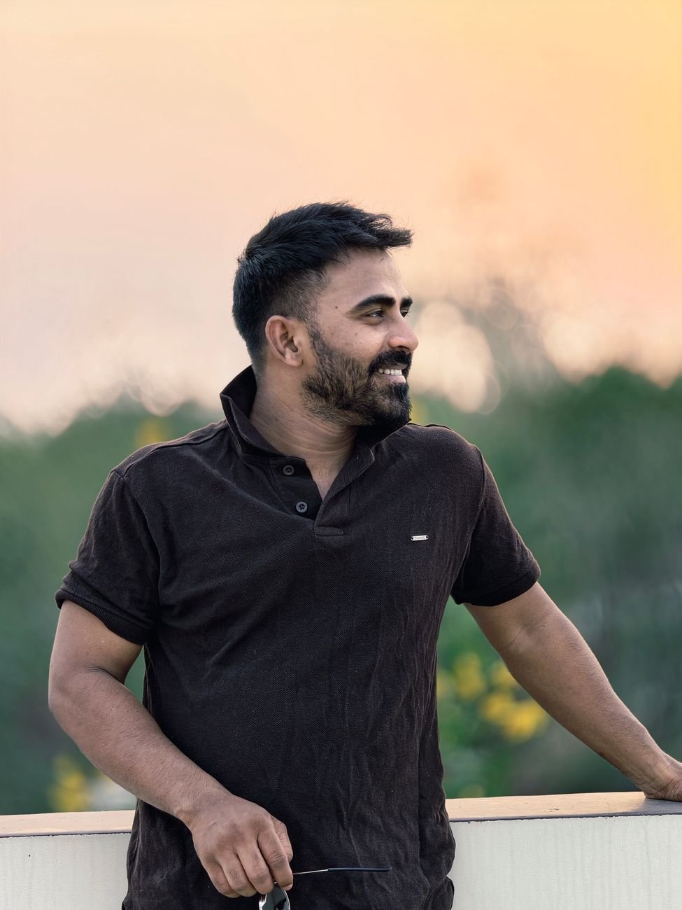 Portrait of a smiling man outdoors during a warm sunset.